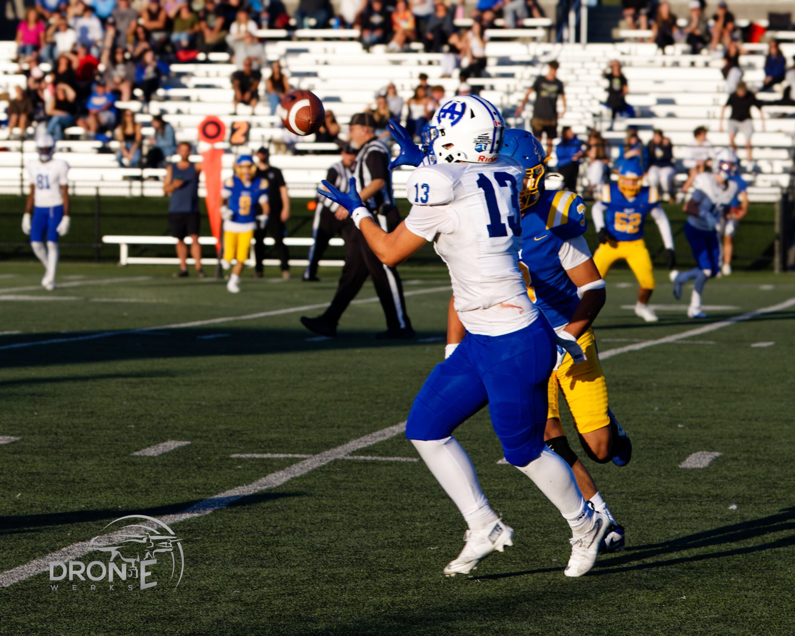 Harry Ainlay Titans football player mid-play