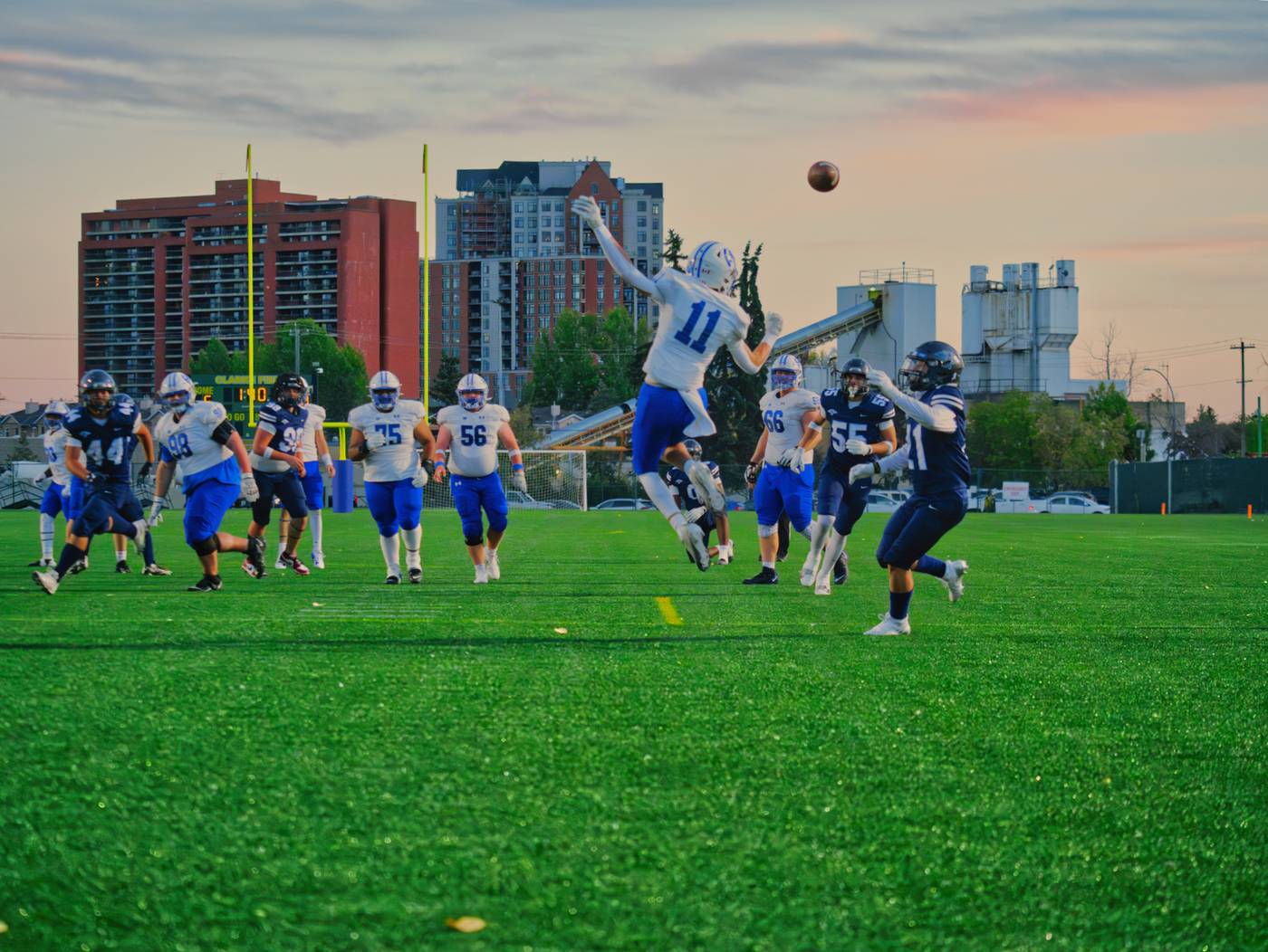 Harry Ainlay Titans football player mid-play