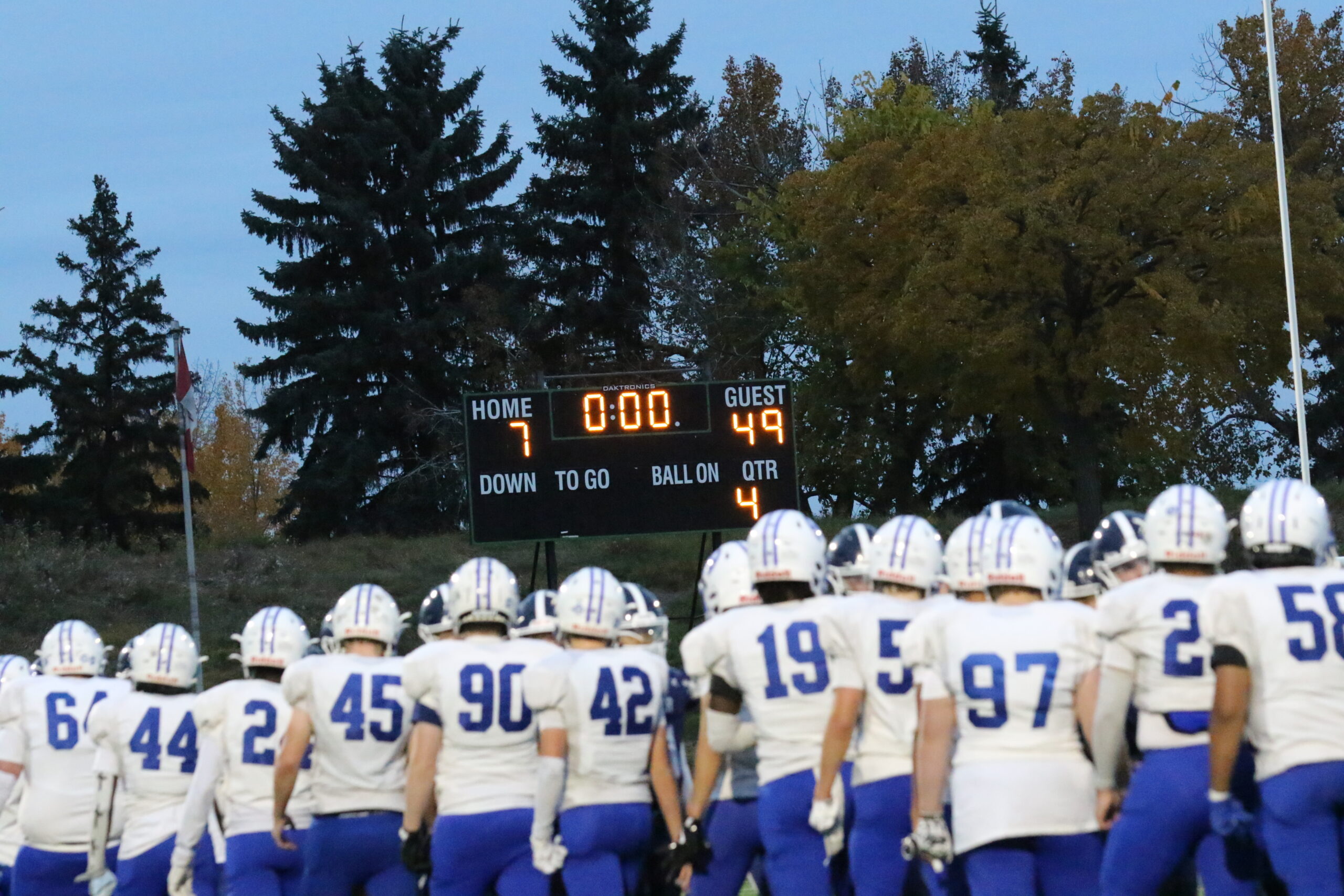 Junior Titans in front of the scoreboard with the final score, Oct 7